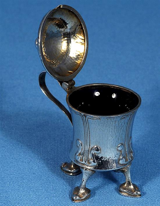 An Edwardian Arts and Crafts Cymric silver mustard pot, designed by Archibald Knox, for Liberty & Co, numbered 409, height 70mm,